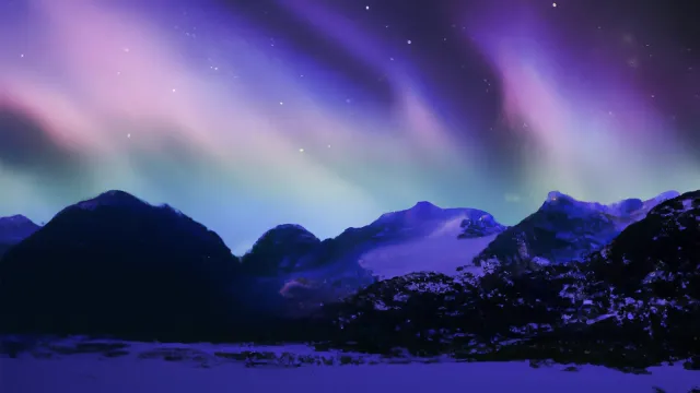 blue to purple aurora in the night sky above a snowy mountain